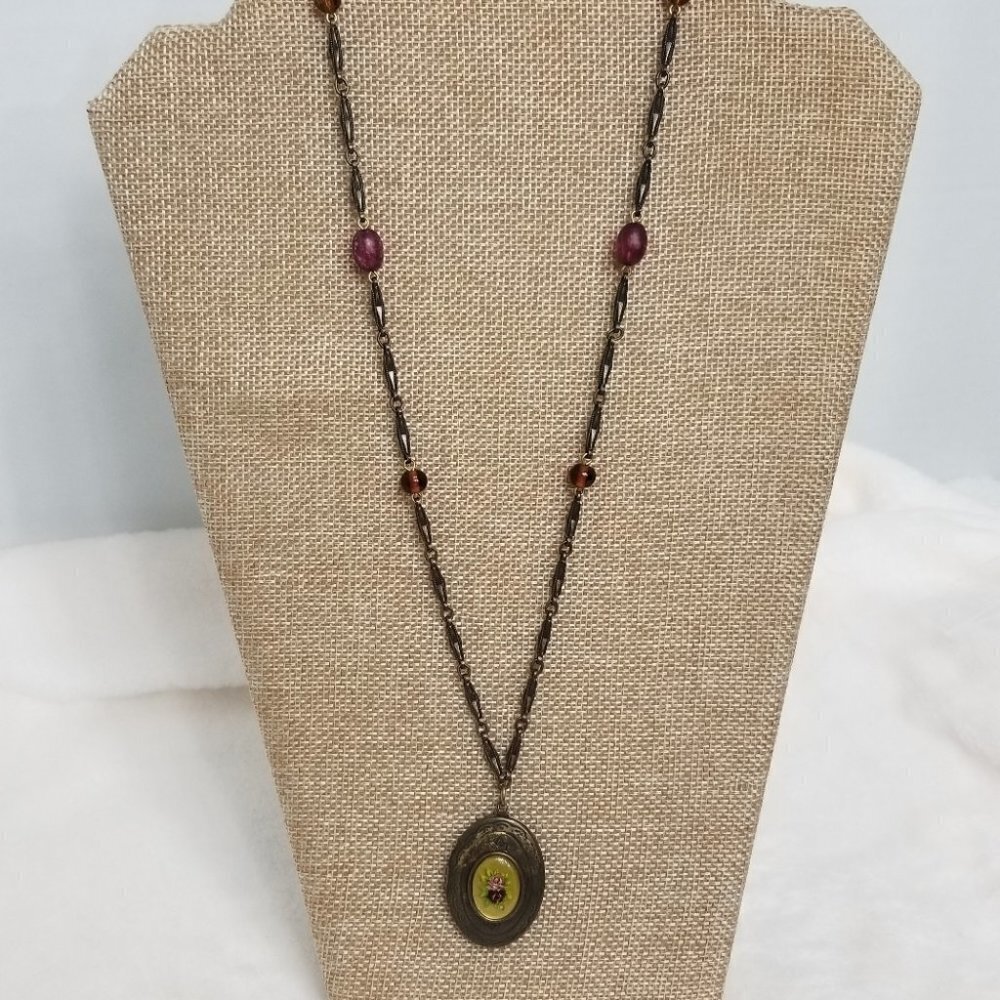 Express Brass tone locket.